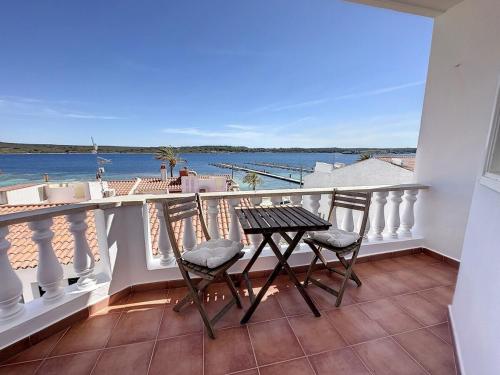 a balcony with a table and chairs and the ocean at F98. Vistas al mar en Fornells! in Fornells
