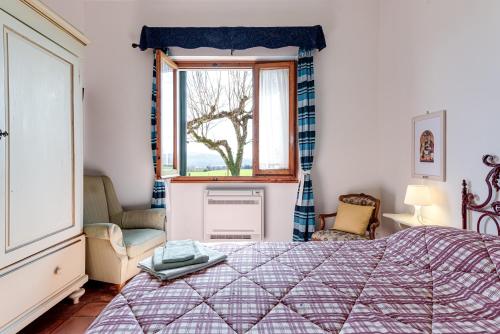 a bedroom with a bed and a window at Relax in Campagna - Mugello Circuit in Scarperia