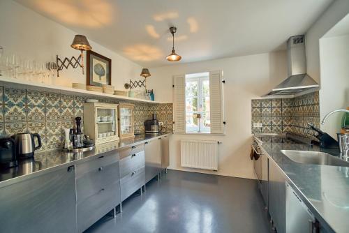 a large kitchen with stainless steel counters and a sink at Linnerhof in Hart