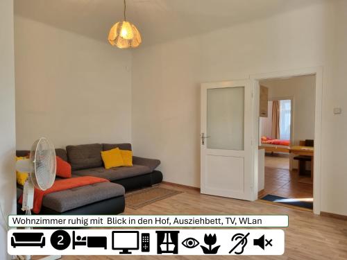 a living room with a couch and an open door at Ferienhaus für Familien und Hundeliebhaber in Traiskirchen