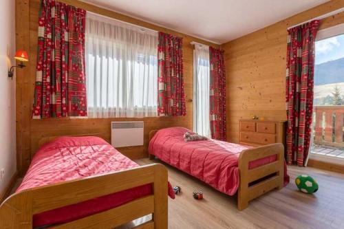 a bedroom with two beds and a window at Lautaret 5 - C5 - Appart spacieux vue - 10 pers in Les Deux Alpes