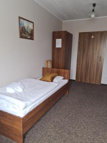 Una cama o camas en una habitación de Gościniec Oaza Sorkwity