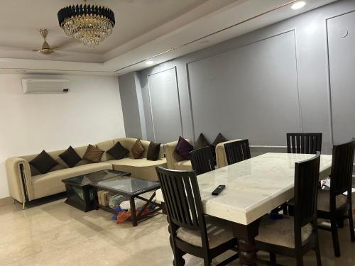 a living room with a table and a couch at Shiv dham in New Delhi