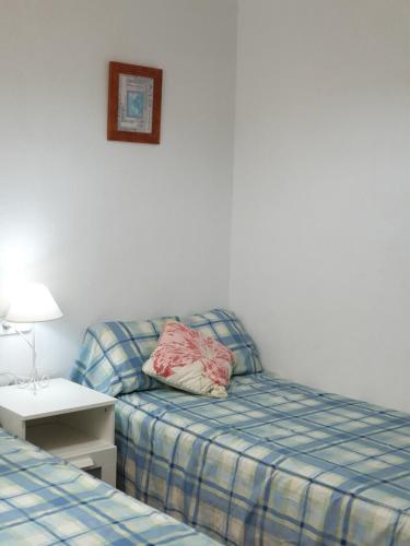 a hotel room with a bed and a pillow next to a bed at F76. Vistas al mar en Fornells! in Fornells