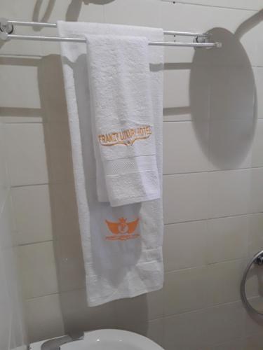 a towel hanging on a towel rack in a bathroom at Franzy Luxury Hotel & Suites in Jos