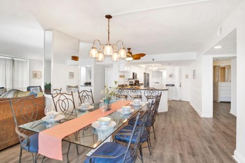 a dining room and living room with a table and chairs at Perdido Sun Unit 116 in Pensacola