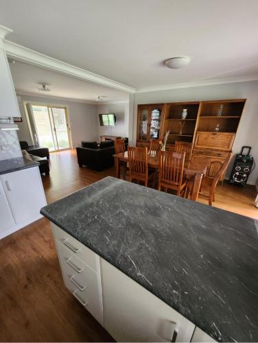 a kitchen and living room with a table and chairs at Kollannoor Homestead in Mitchells Island