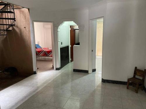 a hallway with four doors and a room with a bed at apartment in neiva goliat in Neiva