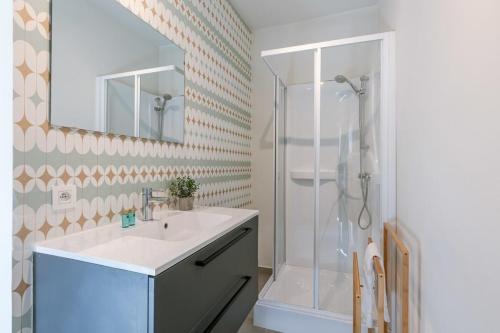 a bathroom with a sink and a shower at Comfortable studio with terrace in Antwerp in Antwerp
