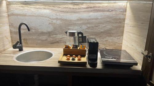 a coffee maker on a counter next to a sink at Le Sidi Cabanas Hacienda Bay in El Alamein