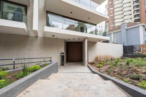 a house with a walkway in front of it at AT HOME El Golf in Santiago