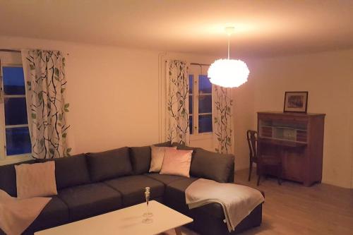 a living room with a couch and a table at Sörgården - hyr hela gården! (2-35 personer.) in Köping