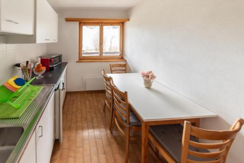 a kitchen with a table and chairs in a room at casa Pagnoncini in Prada