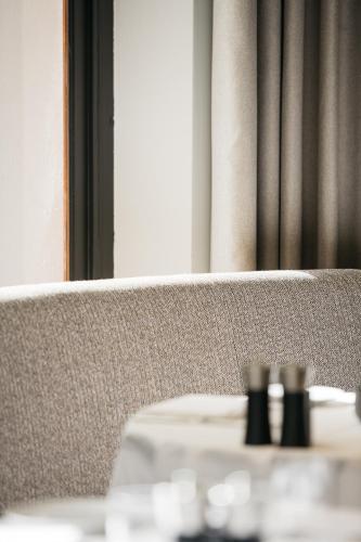 a close up of a bench with a table at Boutique Hotel Beaumont Maastricht in Maastricht