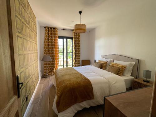 a bedroom with a large bed and a window at Carpediem corsica adult only in Poggio-dʼOletta