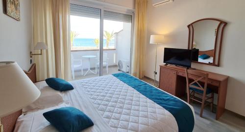 a bedroom with a large bed with a view of the ocean at Hotel Levante - Isola d'Elba in Cavo