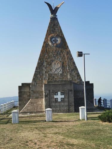 a building with a tower with a clock on it at Apartmani Iva in Banja Koviljača