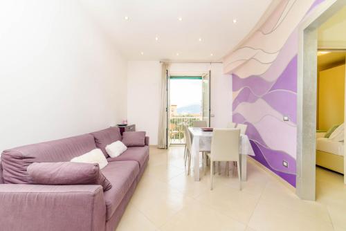 a living room with a purple couch and a table at Estate4home - L'onda viola in Sorrento