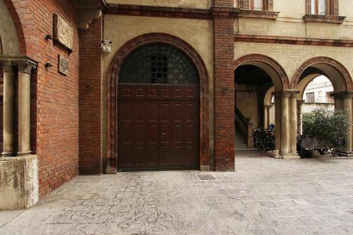 a large brown door on a brick building at SAHI - Residenza Bianca di Savoia in Milan