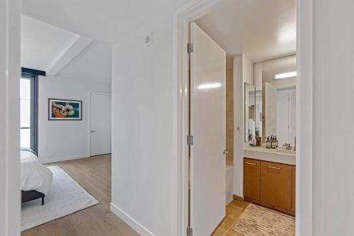 a bedroom with a door leading to a bathroom at Santa Monica Two Bedroom Apartment With Amazing Views in Los Angeles