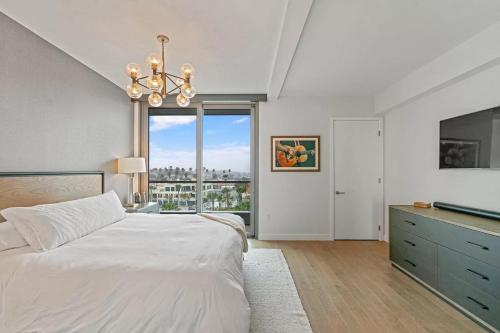 a bedroom with a white bed and a large window at Santa Monica Two Bedroom Apartment With Amazing Views in Los Angeles