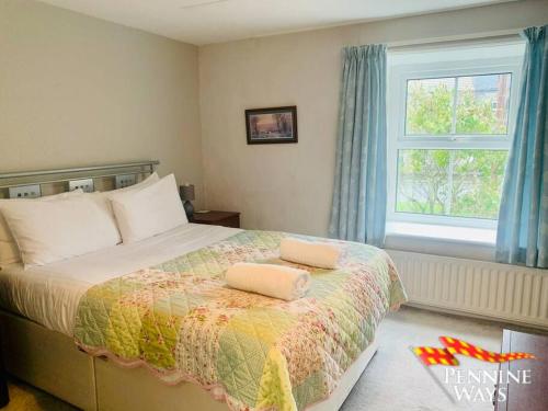 a bedroom with a bed with two pillows on it at Fairleas Farm - Idyllic Countryside Retreat in Saint Johns Chapel