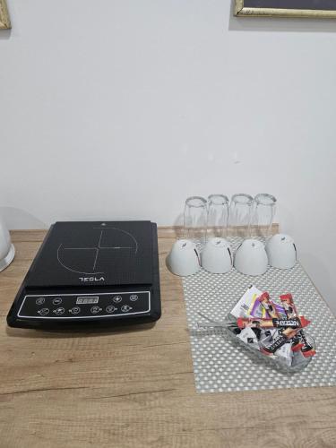 a table with a laptop and wine glasses on it at ForS Konak Apartments in Belgrade
