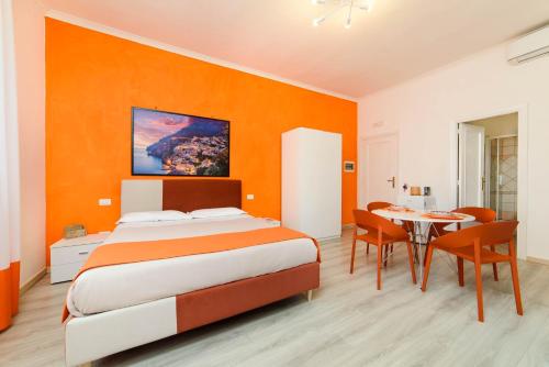a bedroom with a bed and a table and chairs at Estate4home - Casa Laura in Sant'Agnello
