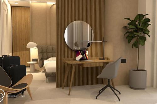 a room with a mirror and a desk with a chair at Old town luxury apartment 2 in Kos