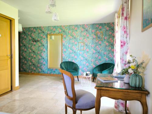 a room with a table and chairs and a mirror at La Grange de Moisey in Marigny-lès-Reullée