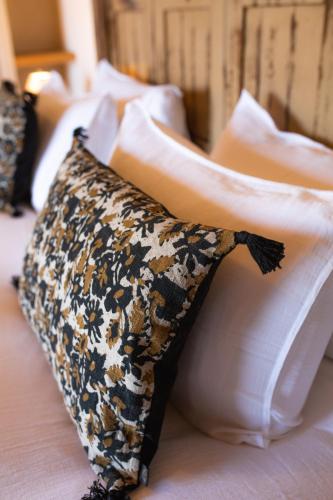 a row of pillows on a bed at Les Demeures de Piana in Piana