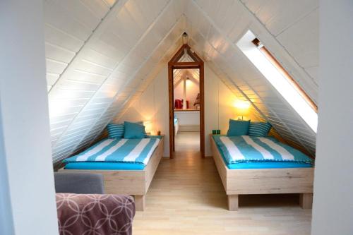 a room with two beds in a attic at Ferienwohnung Bonishof in Westerholt