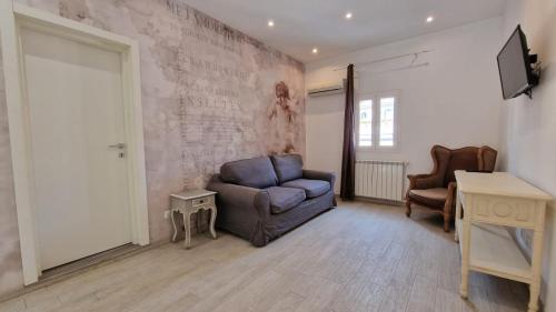 a living room with a blue chair and a table at Major 93 Guesthouse in Rome