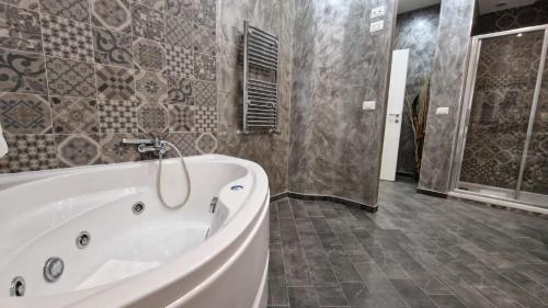 a large bathroom with a tub and a shower at Major 93 Guesthouse in Rome