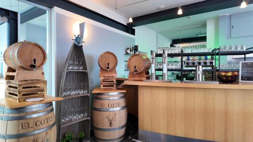 a bar with barrels of wine on the counter at Inselhotel kleiner Bodden in Buschvitz