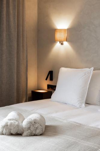 a bed with two towels laying on top of it at Hotel Beach Palace by CW Hotel Collection in Blankenberge