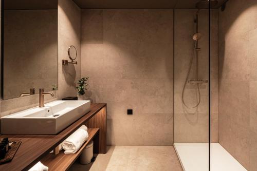 a bathroom with a sink and a shower at Hotel Beach Palace in Blankenberge