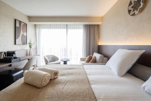 a hotel room with a large bed and a large window at Hotel Beach Palace by CW Hotel Collection in Blankenberge