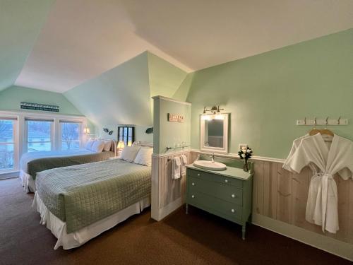 a bedroom with two beds and a sink in it at The Ludington House in Ludington