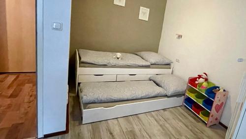 a small bedroom with a bunk bed and a crib at Haus am Soleweg in Ebensee