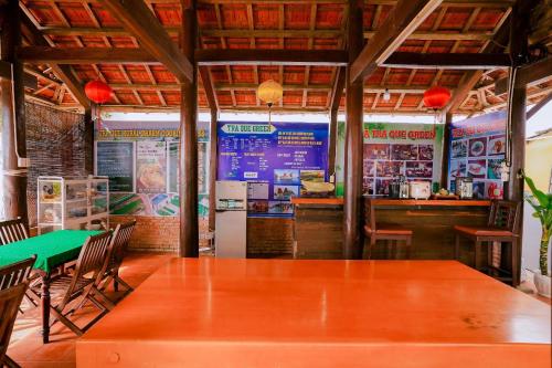 a restaurant with a green table and a bar at Tra Que Green Villa Hoi An in Hoi An