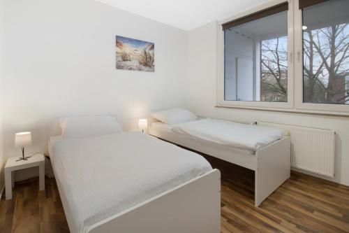 Postel nebo postele na pokoji v ubytování Schickes Apartment mit Balkon