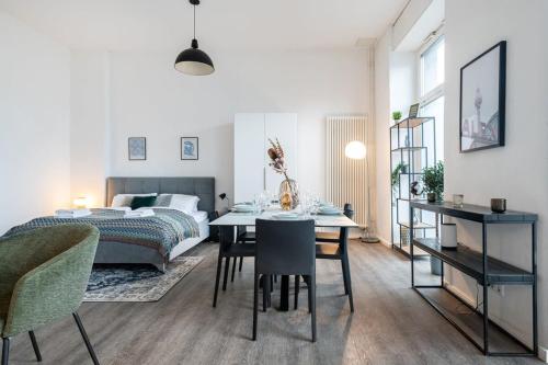 een slaapkamer met een bed en een tafel en stoelen bij City Apartment: Homeoffice und Erholung vereint! in Berlijn