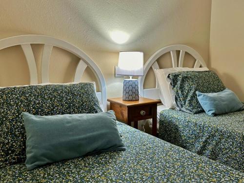 a bedroom with two beds with pillows and a lamp at Los Girasoles - 6806 in Noja