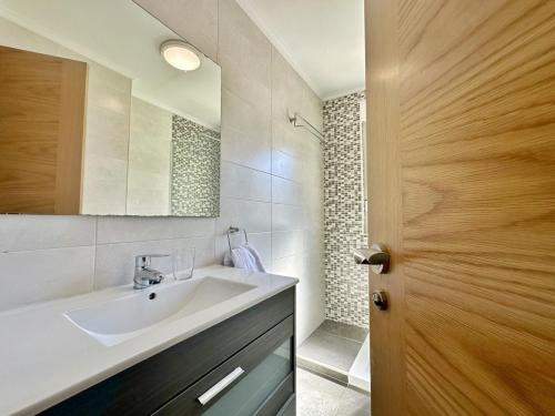 a bathroom with a sink and a mirror at La Esteluca - 6805 in Noja