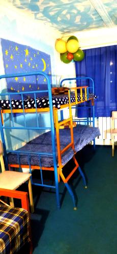 a childrens bedroom with a bunk bed and a table at Asine Yerevan in Yerevan