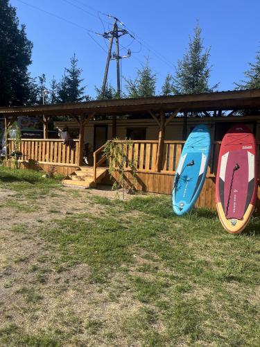 two surfboards on display in front of a house at Holender Przy Plaży in Wilimy