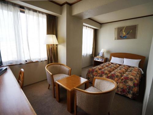 Katil atau katil-katil dalam bilik di Neyagawa Trend Hotel