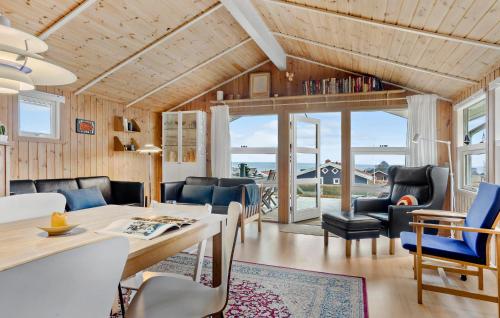 a living room with a table and chairs and a couch at Stunning Home In Sjølund With Kitchen in Sjølund