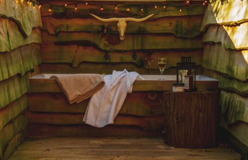 a bathroom with a sink in a log cabin at Koppla Cabin in Felbridge